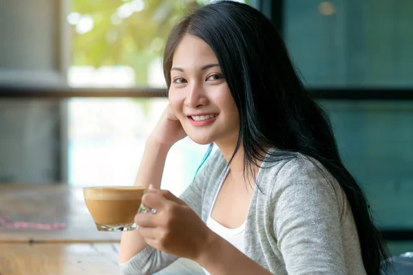 woman drinking cappuccino coffee at vintage coffee cafe.