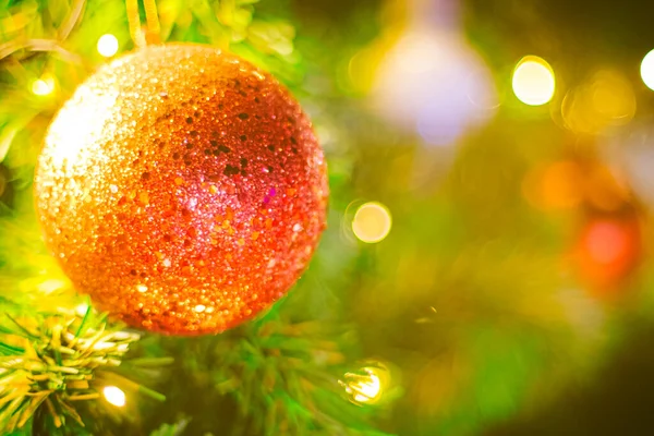 Bokeh arka planındaki kırmızı Noel balosu dekorasyonunu kapat. Renkli bulanık arka plan. Noel arkaplanı