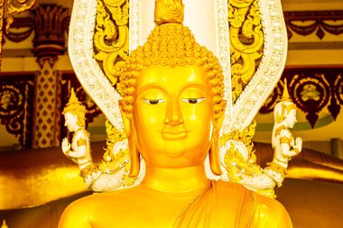 close up face of Golden buddha statue in religiuus asian temple