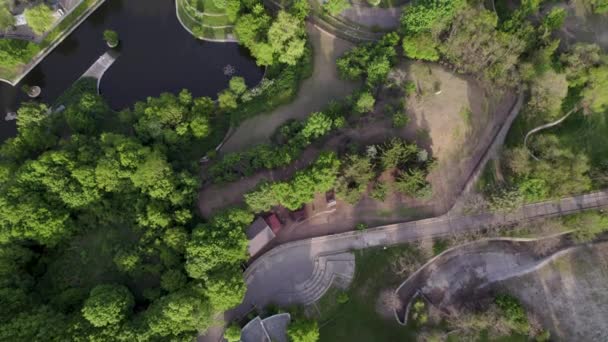 Drone top shot of open animal enclosures with ponds in zoo — Video