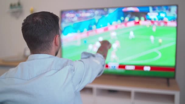 Happy Football Fan Celebrating Win Watching Blurry Home High Quality — Vídeos de Stock