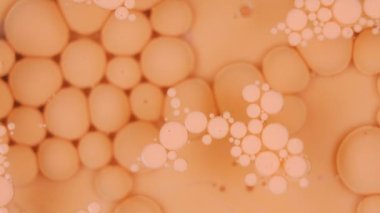 orange ink floating background texture cosmetic rotating . High quality 4k footage