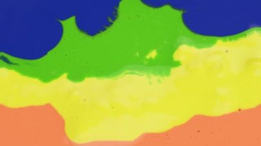 Colorful paint drops mixing in water. Ink swirling underwater. Liquid paint colorful bubbles patterns of moving surface