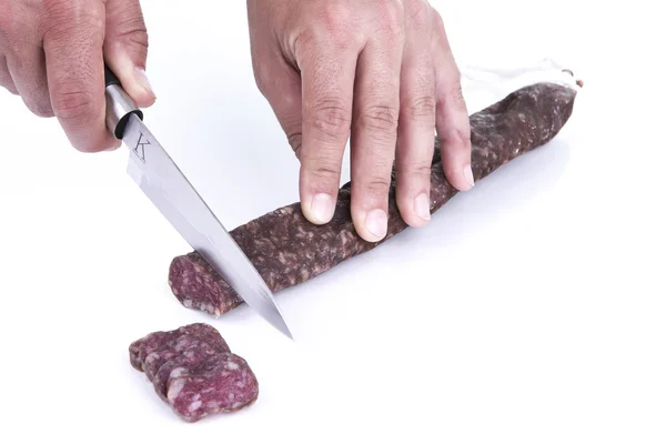 Cutting spanish sausage — Stock Photo, Image