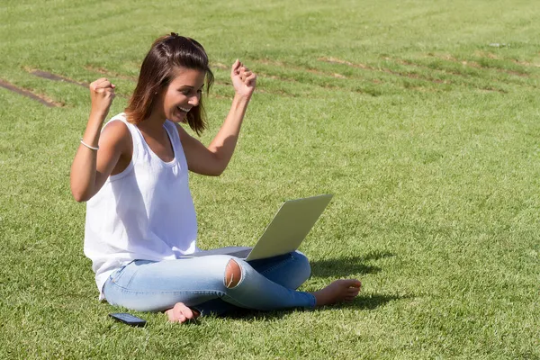 Donna felice utilizzando il computer portatile — Foto Stock