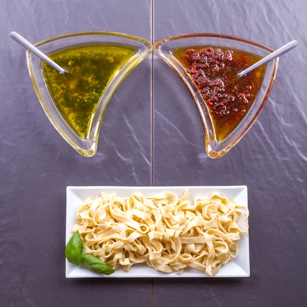 Pasta tagliatelle with tow sauces — Stock Photo, Image