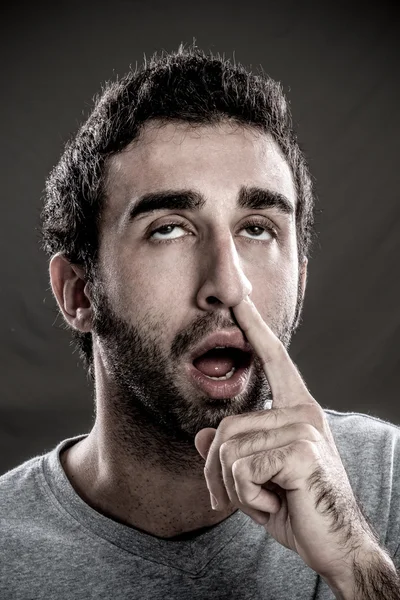 Man with a finger in his nose — Stock Photo, Image