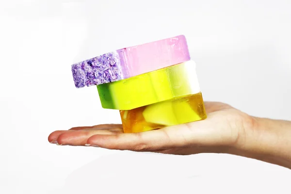 Woman's hand holds out some colored soap Stock Picture