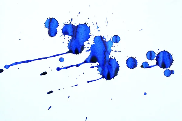 Blauwe inkt vlekken op een vel wit papier Stockafbeelding