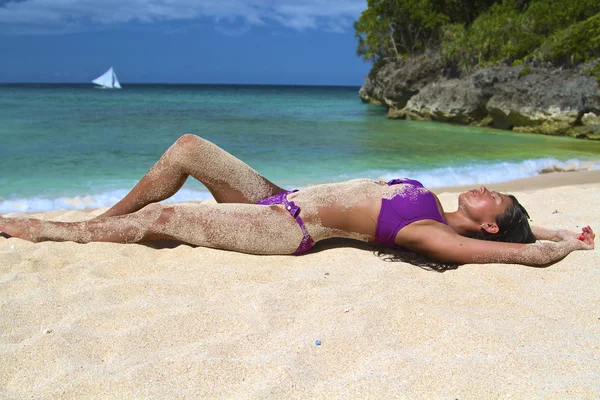 The beautiful sexy young girl in bikini on a beach — Stock Photo, Image