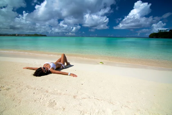 The beautiful sexy young girl in bikini on a beach — Stock Photo, Image