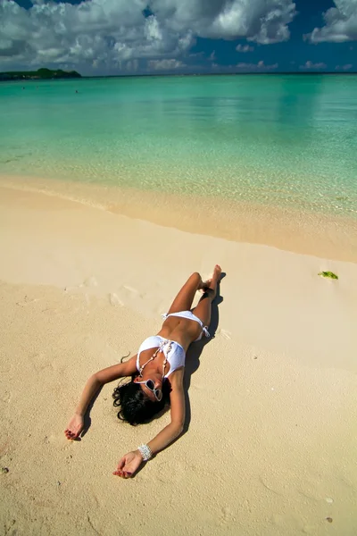 The beautiful sexy young girl in bikini on a beach — Stock Photo, Image