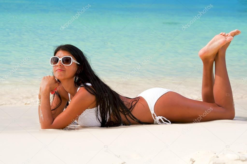 The beautiful sexy young girl in bikini on a beach