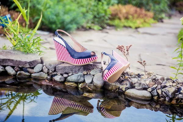 Marine sandals lie beside the pool — Stock Photo, Image