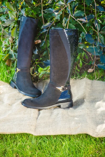 Botas de gamuza negro en el jardín de otoño, zapatos de mujer — Foto de Stock
