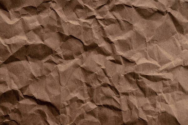crumpled paper. sheet of brown cardboard paper. detailed high resolution texture. abstract background for wallpaper.