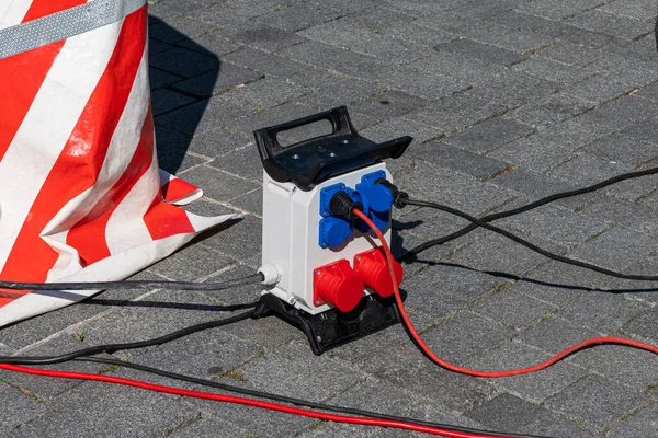 Portable Electricity Distributor Paved Street Black Red Electrical Wires Lie — Stock Photo, Image