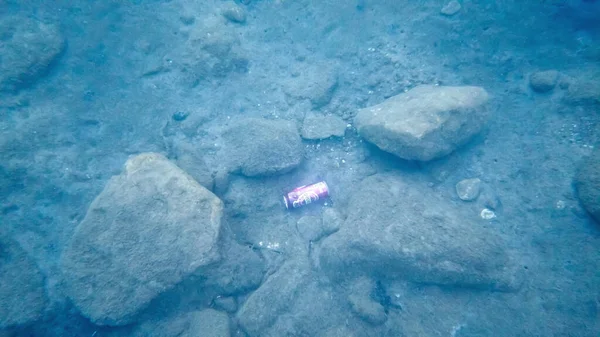 A can of beer on the seabed under water. People left garbage on sea beach. debris pollution of the world\'s oceans. Turkey - September 12, 2021