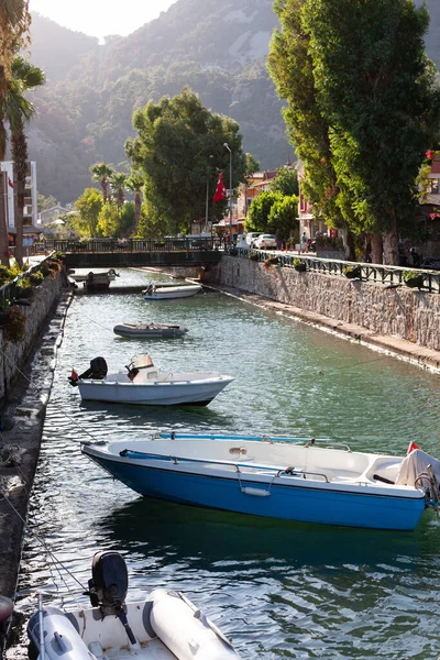 Barcos a motor amarrados en el canal de agua. Pequeño barco pesquero atado en el río en un pequeño pueblo turístico — Foto de Stock