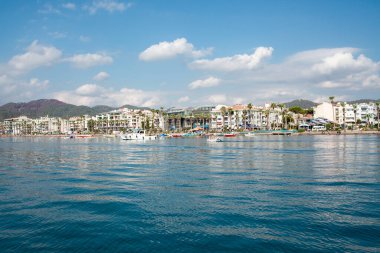 Landscape view of Marmaris city in Turkey. Seaside of resort town with white sand beach. City coastline. Marmaris, Turkey - September 8, 2022.