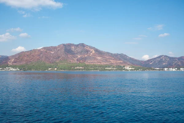 The coast of Turkey near Marmaris city, where the mountains meet the Mediterranean Sea. The shores of Turkey\'s Mugla province. Mountain hills after big forest fire in 2021.