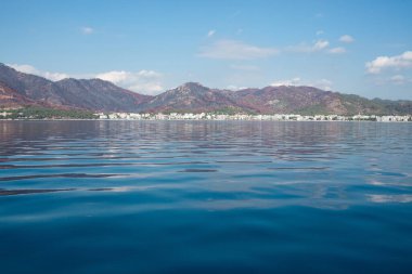 Landscape view of Marmaris city in Turkey. Seaside of resort town with white sand beach. City coastline. Marmaris, Turkey - September 8, 2022.