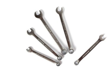 Spanners lies on table in shape of hand isolated on white background. Chrome vanadium metal wrench close up. Helping hand concept. Service concept