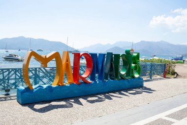 The inscription Marmaris in multicolored letters on the city embankment. Welcome sign in resort town Marmaris. Marmaris, Turkey - September 8, 2021