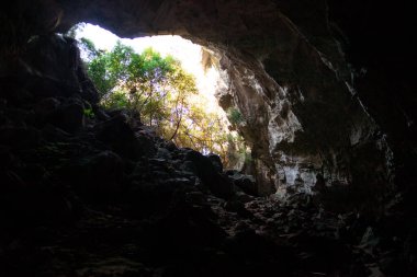 Entrance to in cave of Nimara Magarasi, Turkey. Stone walls and rocks in natural cave. stones covered with moss.