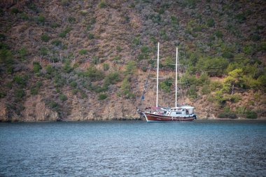White sailing yacht moored in Aegean sea near Turkey coast. Luxury white boat yacht. Ships in sea. Sea traveling. View from boat. Marmaris, Turkey - September 9, 2022.