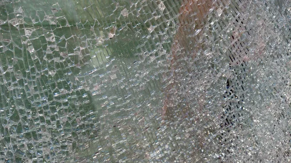 Strained glass broken window from explosion splinter. Shattered glass. Abstract blurred defocused broken glass texture background. Abstract background. Blurred image.