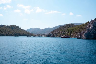 Moored motor boats and ships in the sea near resort town Marmaris. Marina in Marmaris. Marmaris, Turkey - September 7, 2021