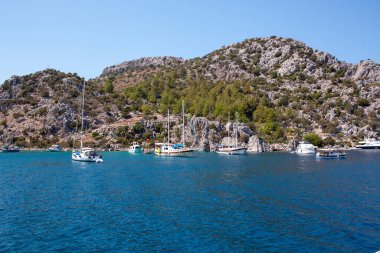 Moored motor boats and ships in the sea near resort town Marmaris. Marina in Marmaris. Marmaris, Turkey - September 7, 2021