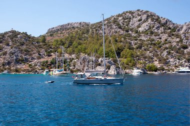 White sailing yacht moored in Aegean sea near Turkey coast. Luxury white boat yacht. Ships in sea. Sea traveling. View from boat. Marmaris, Turkey - September 9, 2022.
