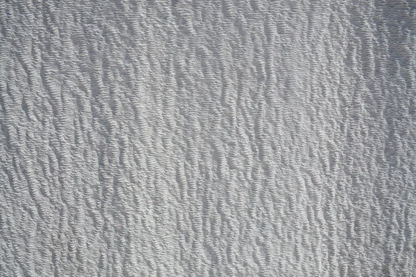 Background of natural white wall Pamukkale calcium travertine in Turkey, asymmetric pattern close-up. White cotton castle texture. Calcium stone textured. Limestone