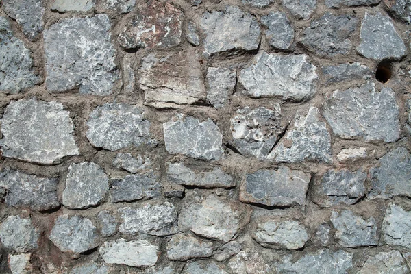 Eski taş duvar dokusu arka planı. Sert taş duvar. Büyük sert taş çitler..