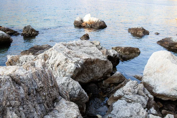 Rocks and stones in the sea. Sea stones. Rough stone surface texture.