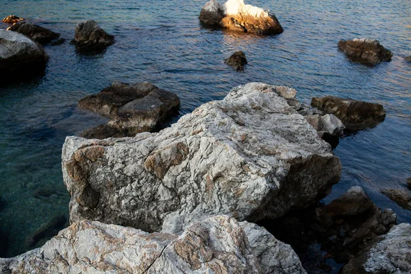 Rocks and stones in the sea. Sea stones. Rough stone surface texture.