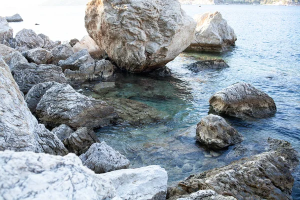 Rocks and stones in the sea. Sea stones. Rough stone surface texture.