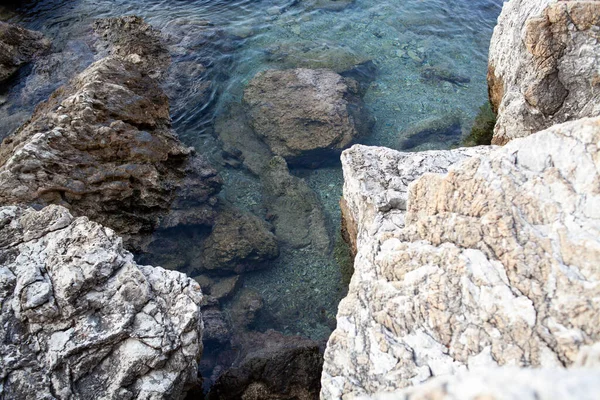 Rocks and stones in the sea. Sea stones. Rough stone surface texture.