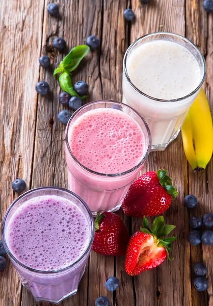 Frutas frescas batido de leite em madeira — Fotografia de Stock