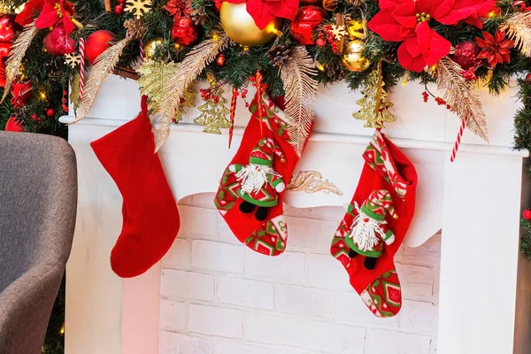 Bright Colorful Red Socks Santa Claus Gifts Hanging White Fireplace — Stock Photo, Image