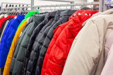 MINSK, BELARUS - 22 Mart 2021: Perakende giyim mağazasında asılı farklı kıyafetler.