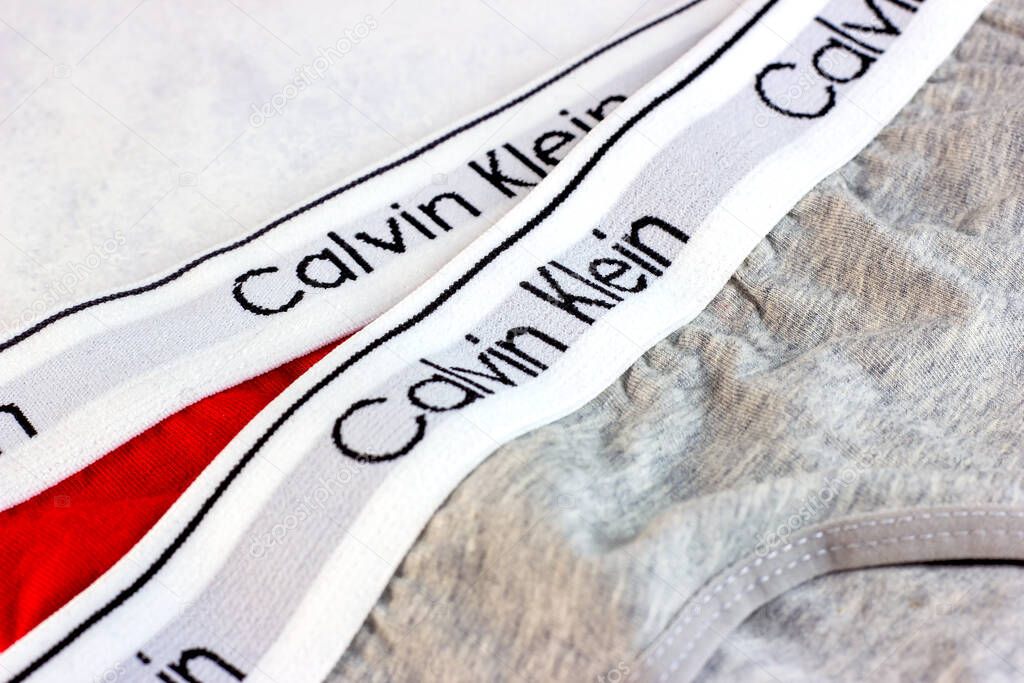 MINSK, BELARUS - NOVEMBER 29, 2021: New gray underwear with Calvin Klein brand logo on light background.