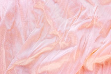 Açık renkli pembe renkli dalgalı naylon ve yumuşak desenli arka plan olarak poliyamit tekstil deseni. Soluk renkli yumuşak kumaş örtüsü..