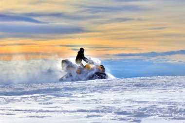 Snowmobile at Sunset clipart