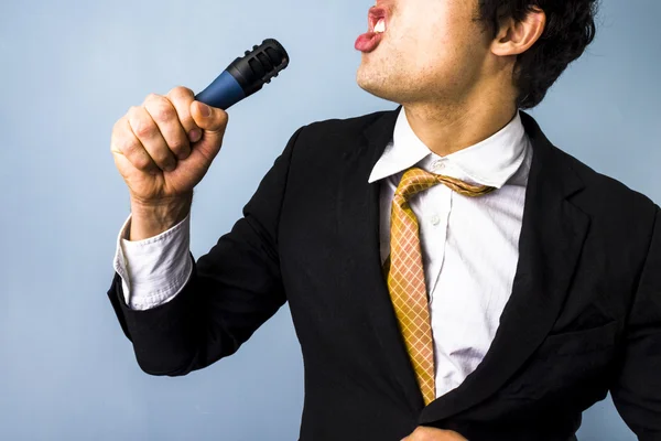 Businessman singing karaoke — Stock Photo, Image