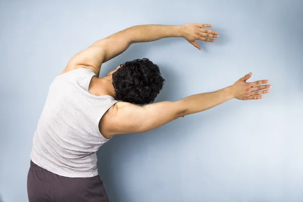 Young mixed race man in side stretch — Stock Photo, Image