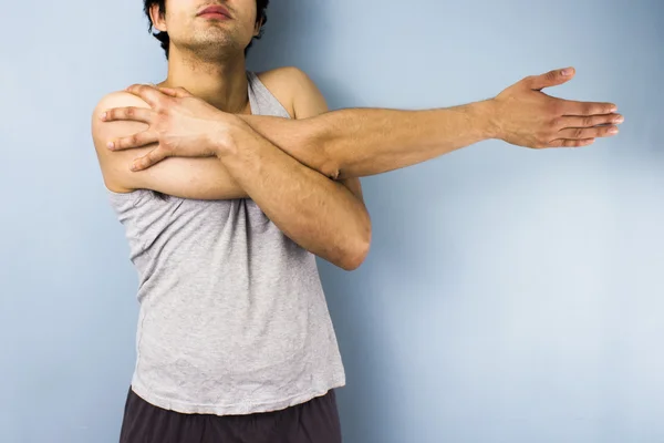 Joven hombre de raza mixta estirando su brazo —  Fotos de Stock