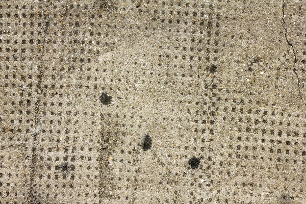 Helle Zementwand mit dunklen Punkten — Stockfoto